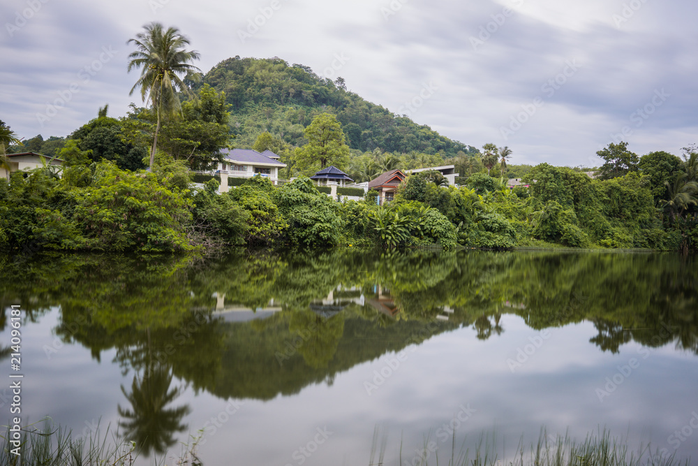 Lake Reflection in the Phuket, Thailand. Surface of lakes like a mirror reflect the image above, double image of landscape. 