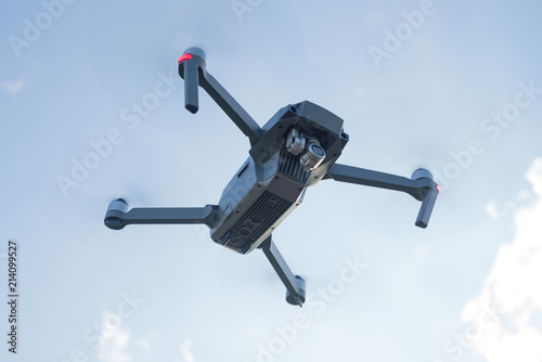 Flying quadcopter drone with Action Camera in the air