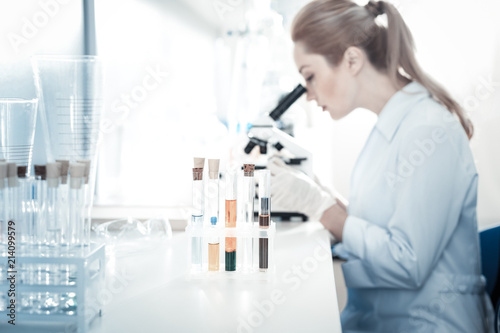 Biological samples. Selective focus of test tubes standing on the table while being used for the research in the biological lab