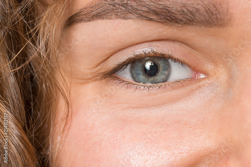 The close up eye on face of young beautiful caucasian girl