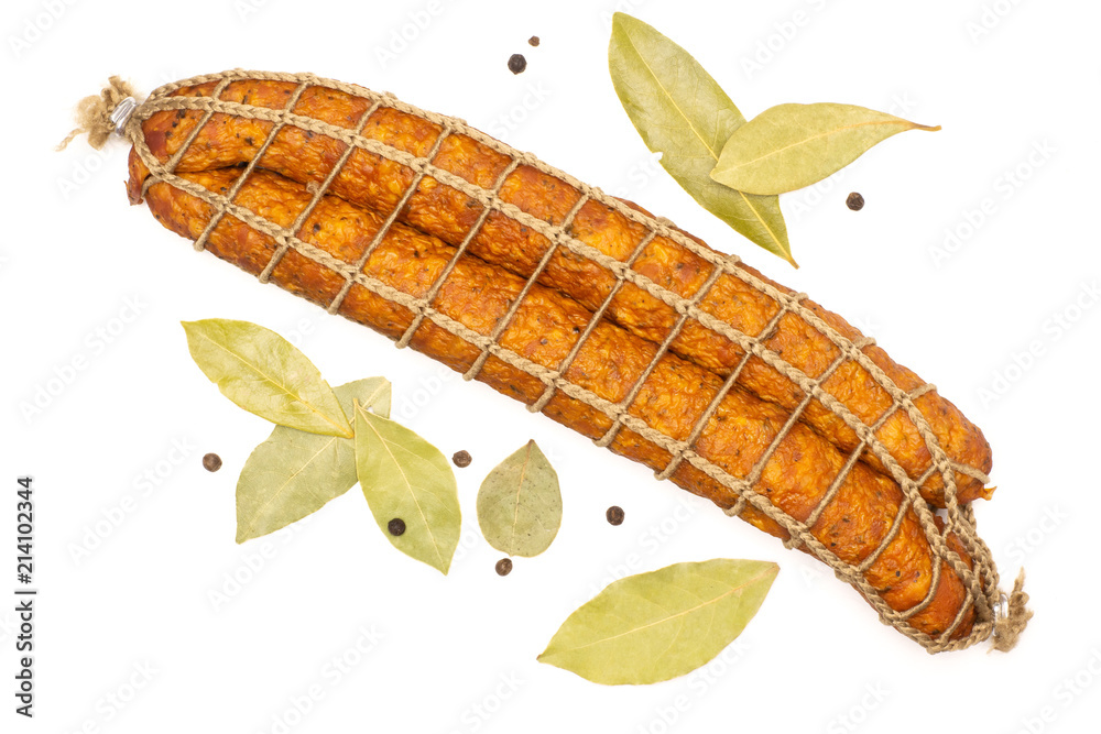 Group of two whole dry smoked ham sausage with dry bay laurel leaves and pepper flatlay isolated on white Group of two whole dry smoked ham sausage with dry bay laurel leaves and pepper flatlay isolated on white