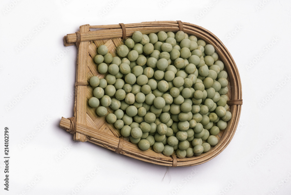 Green peas in cane basket isolated on white background Green peas in cane basket isolated on white background