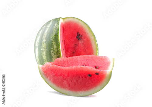 A large ripe watermelon and two slices are next to a white background. isolated