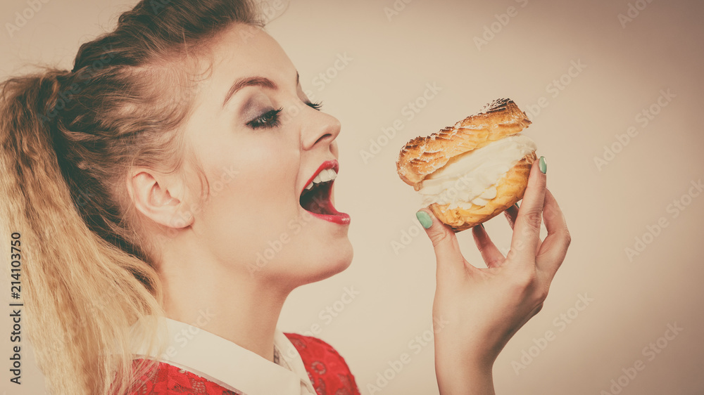 Funny woman holds cream puff cake Funny woman holds cream puff cake