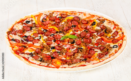 Pizza with sausages and minced meat