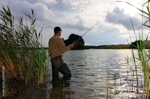 Angler catching the fish during stormy weather