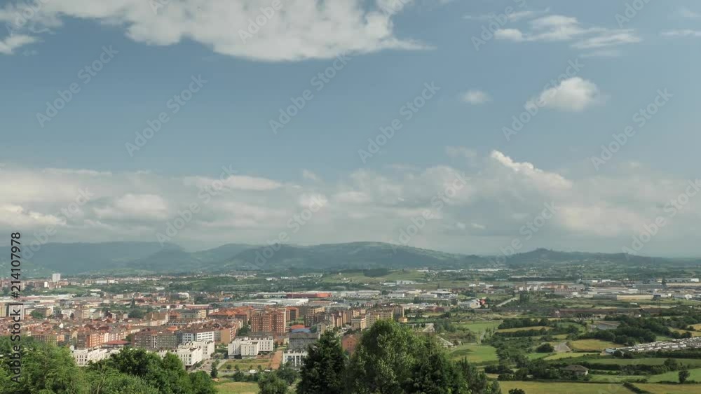 4 k Time-Laps frame posterise fasted video with view of small cosy Spanish town with speedy moving clouds, panoramic green hills, city buildings 4 k Time-Laps frame posterise fasted video with view of small cosy Spanish town with speedy moving clouds, panoramic green hills, city buildings