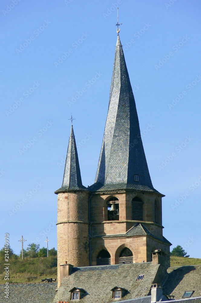 Bell tower with twisted roof of the church in the village Saint Côme d'Olt, Aveyron, France 