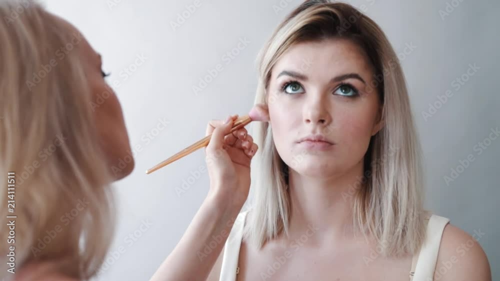 Make-up. Young Beautiful Girl making makeup with brush on cheeks. Make-up. Young Beautiful Girl making makeup with brush on cheeks.
