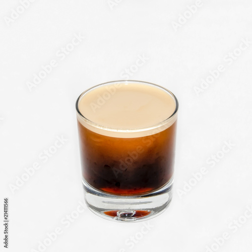 Nitrogen Infused Cold Brew Coffee in a clear glass on a white  background.