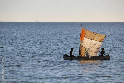 Three boys color sailing in the sea