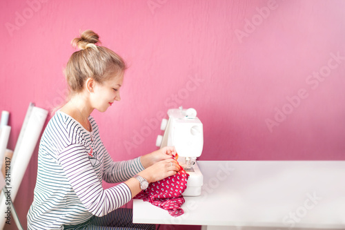 Fashion Design Sewing Machine Concept. Dressmaker woman working with sewing machine.