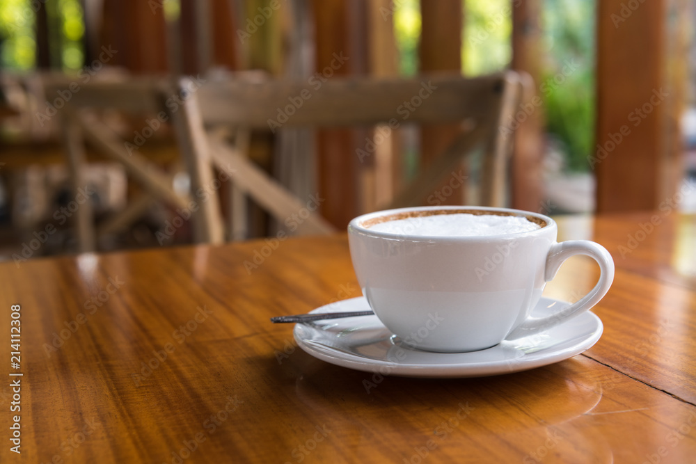 Cappuccino cup on wooden table Cappuccino cup on wooden table