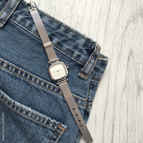 Women's wristwatch on the background of jeans photo