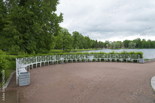 Summer Park with white benches and footpaths. photo