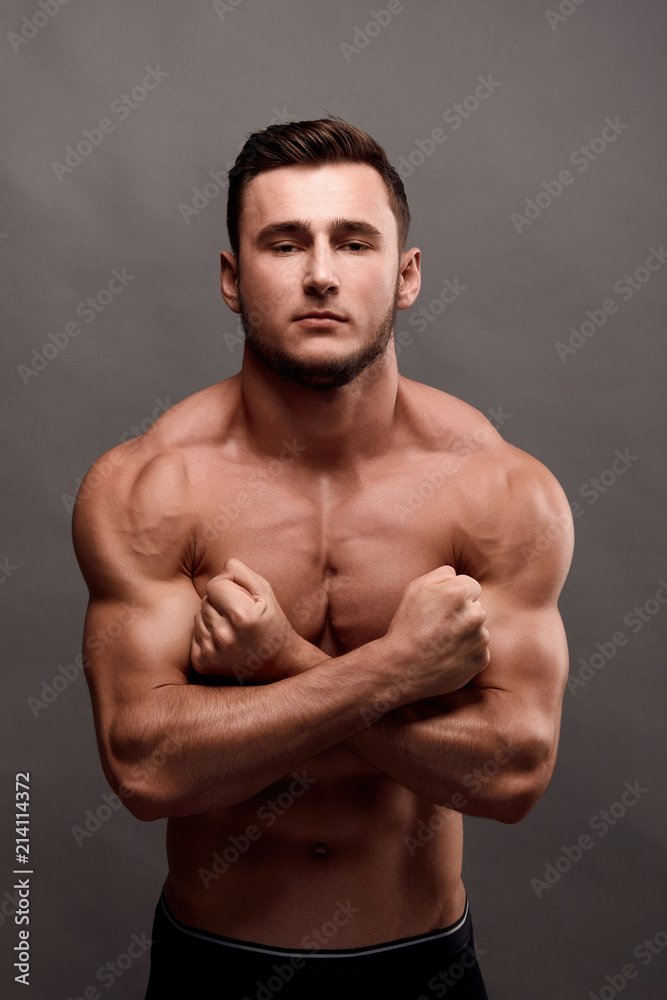 Fototapeta premium Athletic Man Fitness Model Torso showing big muscles.