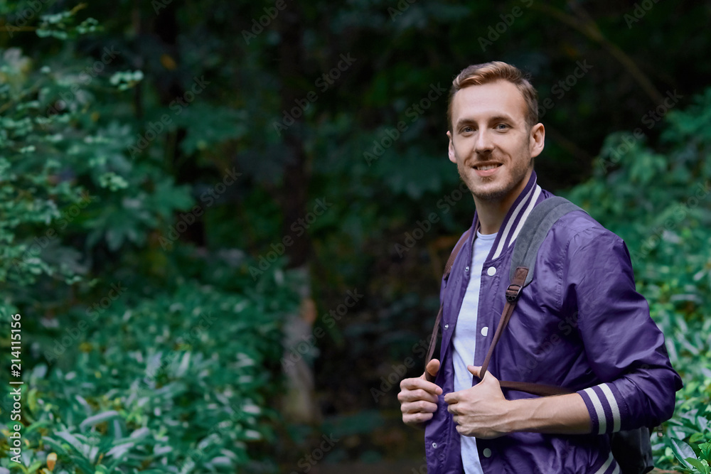 Man traveling in the forest with backpack Man traveling in the forest with backpack