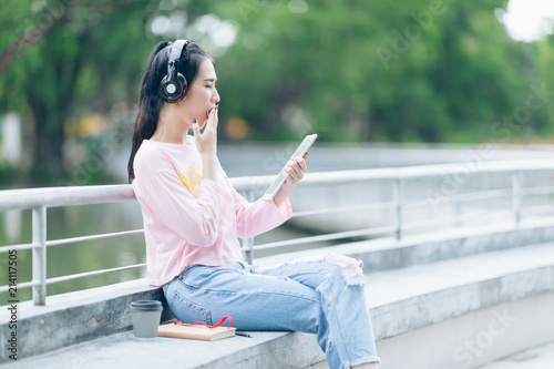 attractive asian woman play social media on tablet Free Download attractive asian woman play social media on tablet - GFXLoad