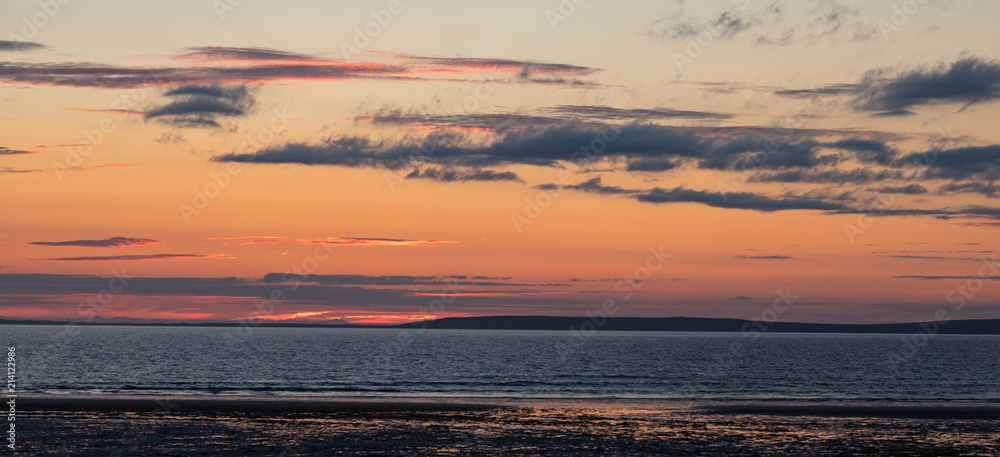Calm and tranquil Atlantic ocean beach panorama at dusk 