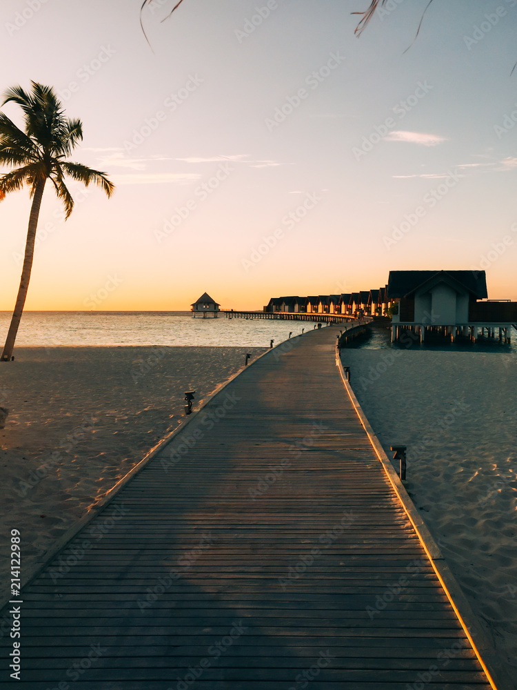 Maldives island luxury beach resort sunset