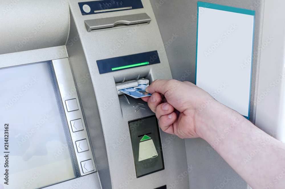 Man hand puts card, press button gray ATM Man hand puts card, press button gray ATM