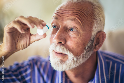 Elderly Person Using Eye Drops photo