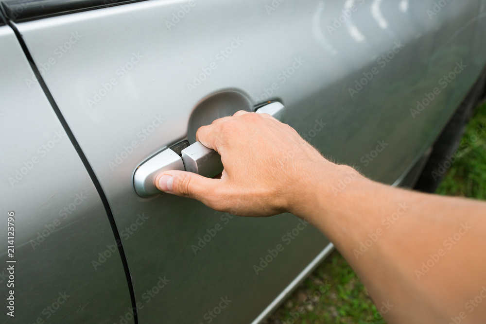 hand on the car handle. open the door to the car. closing the door