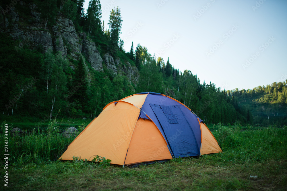 Camping in the clearing in the morning. Tents in the camping in the evening. recreation group of people