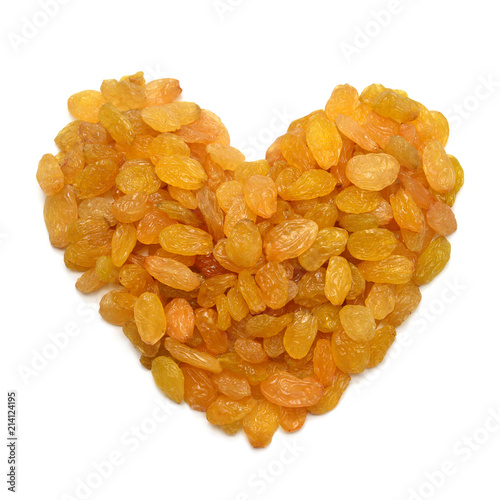 Raisins yellow golden in the form heart isolated on white background. Flat lay, top view