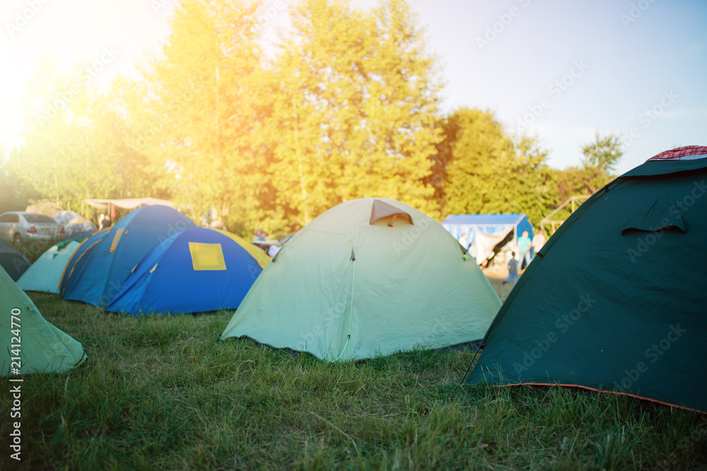 Camping in the clearing in the morning. Tents in the camping in the evening. recreation group of people