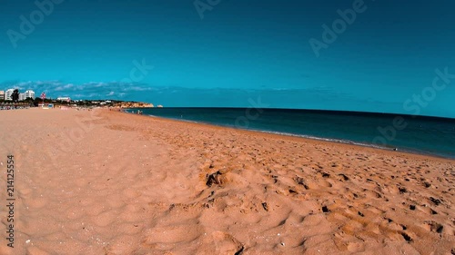Sunny day at sand beach, people relaxing, sunbathing, family summer vacation 