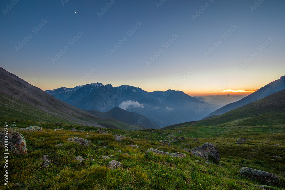 majestic panoramic summer sunset in a mountainous green valley