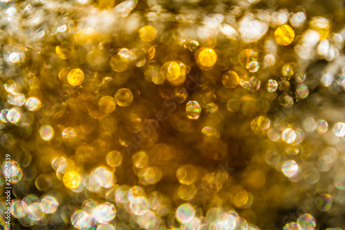 Abstract iridescent and golden bokeh background, glowing yellow circles