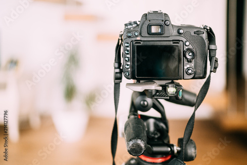 dslr camera sitting on tripod and taking photographs. Interior design photography gear photo