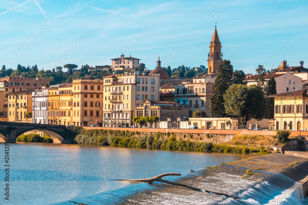 Colorful old buildings line the Arno River in Florence, Italy