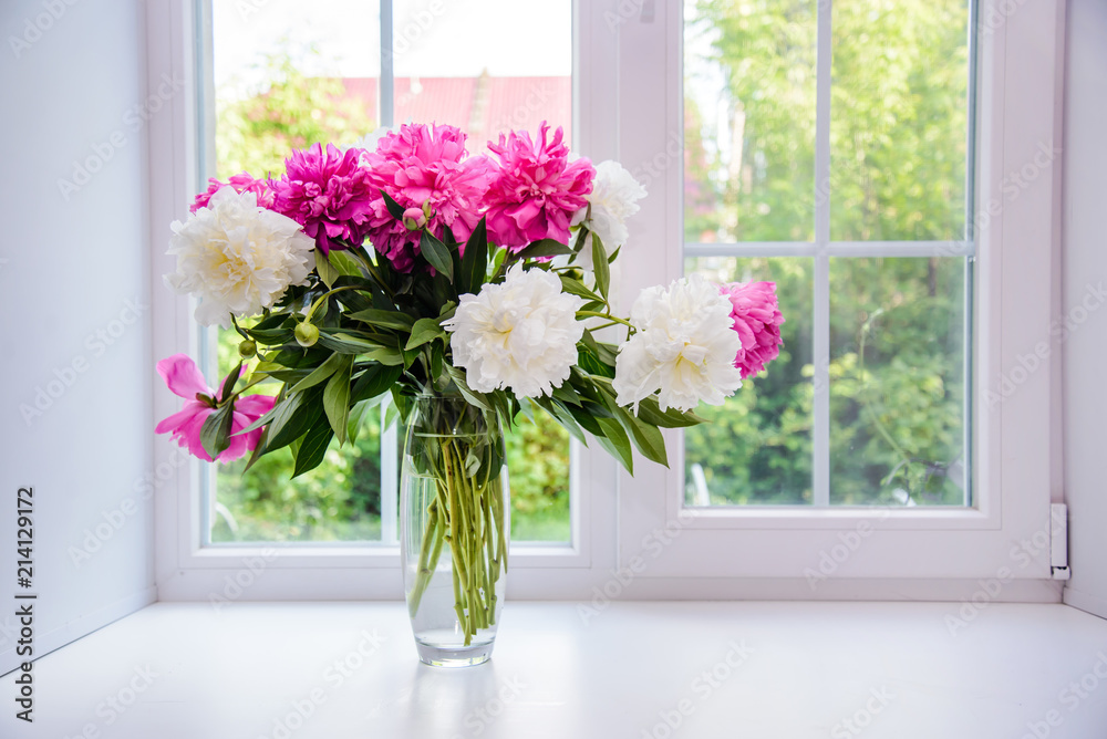 Bouquet of white and pink peonies on the windowsill Bouquet of white and pink peonies on the windowsill