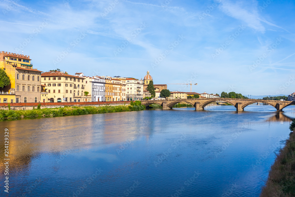 Obraz premium Colorful old buildings line the Arno River in Florence, Italy