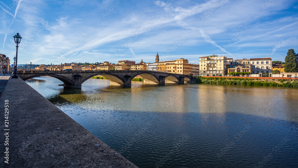 Colorful old buildings line the Arno River in Florence, Italy