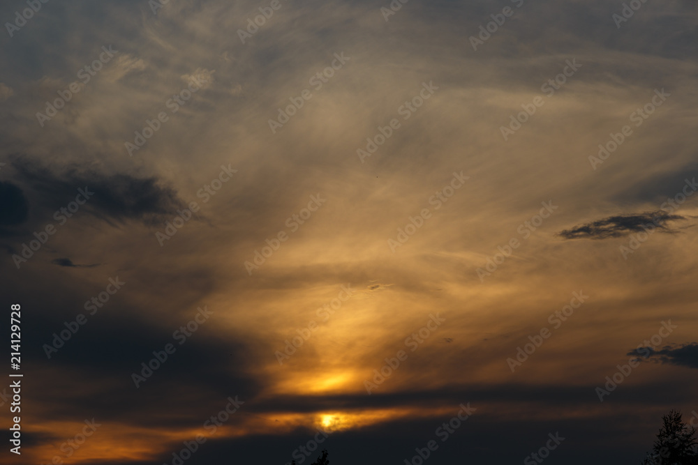 Dramatic sunset sky with clouds. Colorful sunset. Background at dark sky