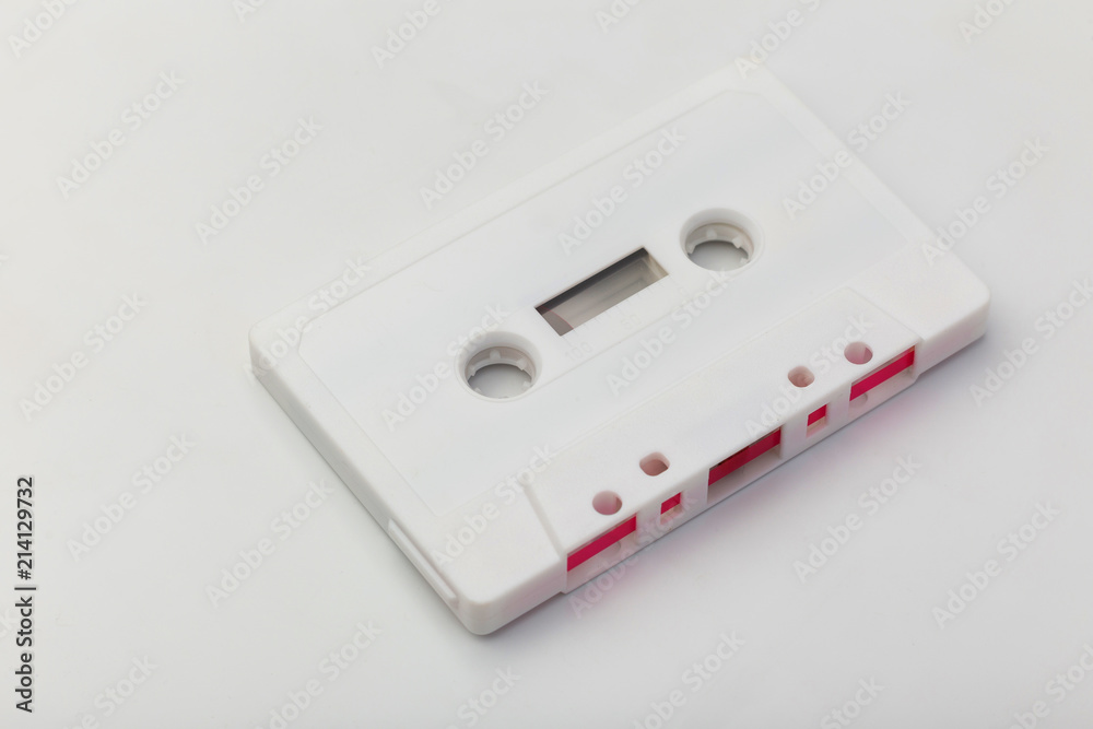 white audio cassette with pink film on white background white audio cassette with pink film on white background