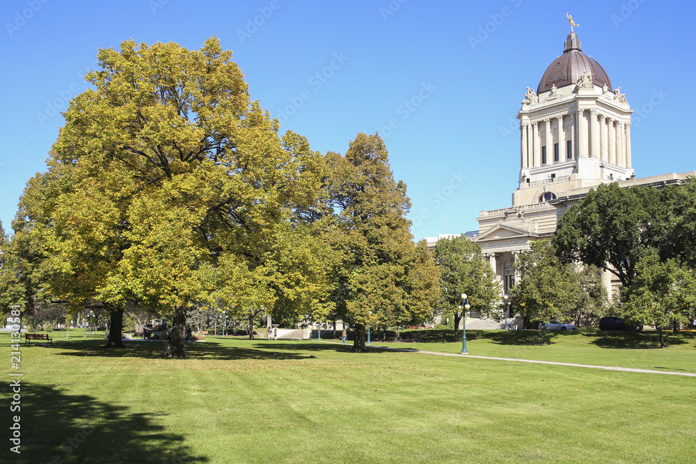 Winnipeg, Manitoba/Canada - September 17, 2016: Beautiful green park with the Manitoba Legislative Building on the background. Winnipeg, Manitoba/Canada - September 17, 2016: Beautiful green park with the Manitoba Legislative Building on the background.