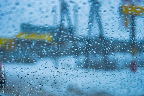 Texture of glass with drops of water on a rainy autumn day