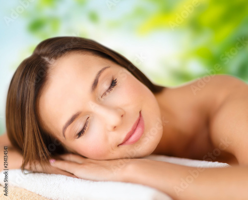 wellness  spa and beauty concept - close up of beautiful woman over green natural background