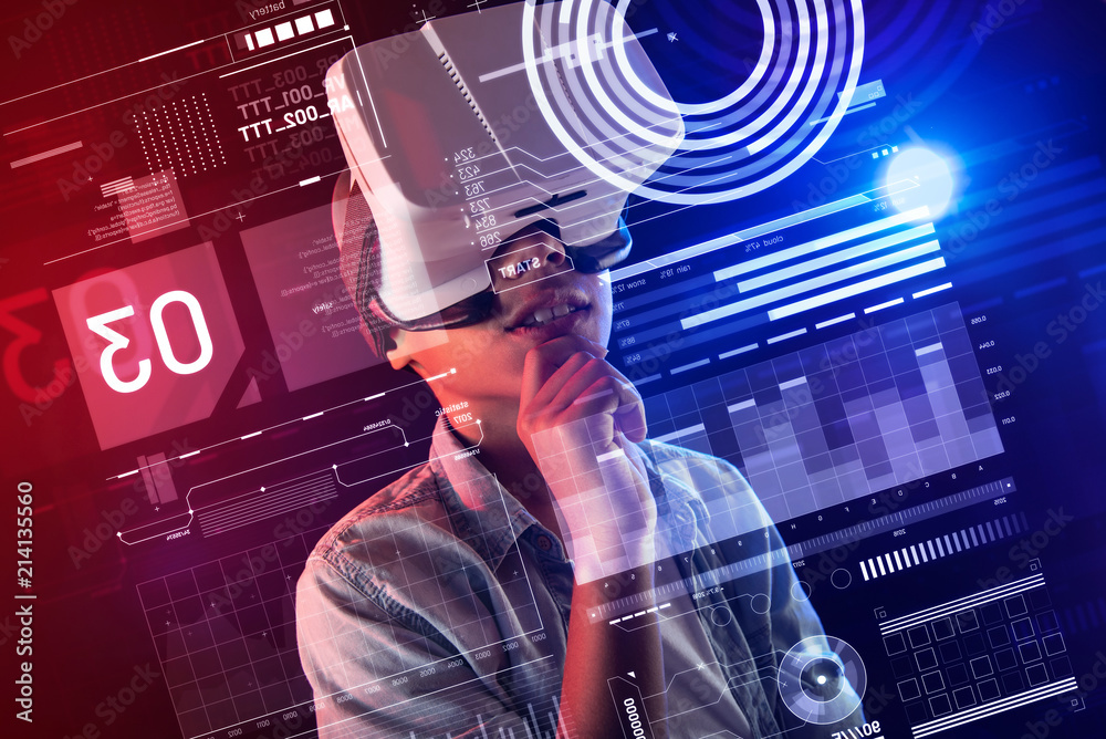 Virtual life. Clever creative boy wearing virtual reality glasses and ...