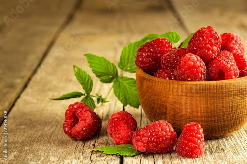 Fresh raspberries on a wooden table. Forest fruit. Healthy food. Sale of raspberries.