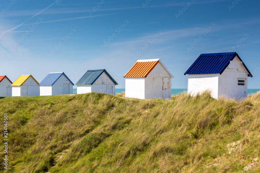 Colorful wooden beach cabins in the dunes, Gouville-sur-Mer, Normandy, France Colorful wooden beach cabins in the dunes, Gouville-sur-Mer, Normandy, France