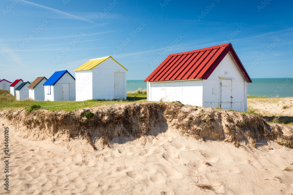 Colorful wooden beach cabins in the dunes, Gouville-sur-Mer, Normandy, France Colorful wooden beach cabins in the dunes, Gouville-sur-Mer, Normandy, France