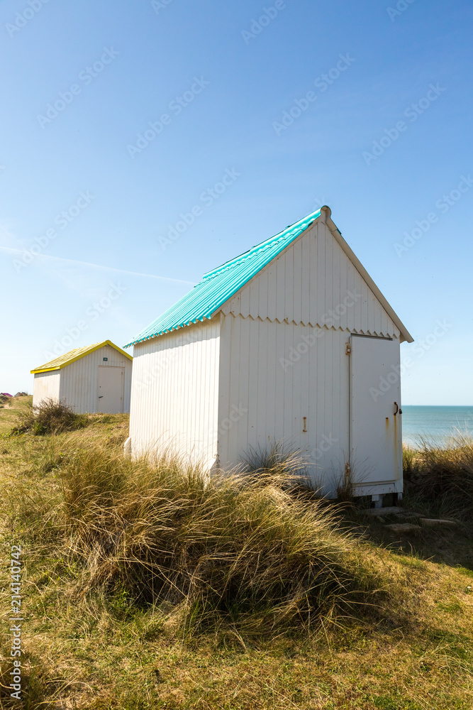 Colorful wooden beach cabins in the dunes, Gouville-sur-Mer, Normandy, France Colorful wooden beach cabins in the dunes, Gouville-sur-Mer, Normandy, France