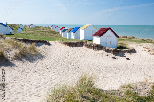 Colorful wooden beach cabins in the dunes, Gouville-sur-Mer, Normandy, France