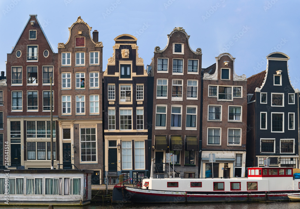 Classic crooked Amsterdam buidlings at house boats, Netherlands